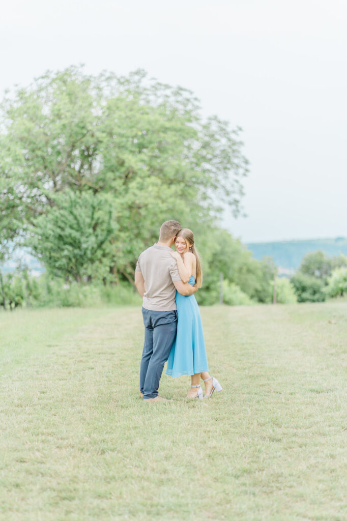 Paarfotos und Hochzeitsfotos in den Weinbergen Süßes Paar in Türkise Kleid und Chino vor einem großen Baum und einem charmanten Steinweg